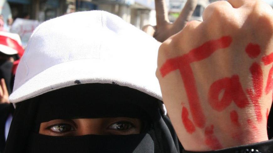 A Yemeni women wears a lock around her wrist with the name Taiz painted in red on her hand, during a demonstration in Taiz, south of the capital Sanaa on December 5, 2011. Forces loyal to Yemeni President Ali Abdullah Saleh shot dead a woman and wounded six other people when they opened fire on a crowd of protesters, medics said.AFP PHOTO/STR (Photo credit should read -/AFP/Getty Images)