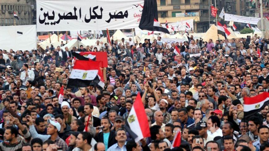 A banner saying "Egypt for all Egyptians," hung in the middle of Cairo's Tahrir Square where tens of thousands of protesters called on President Morsi to withdraw his latest constitutional declaration that granted him massive, unchecked executive powers.