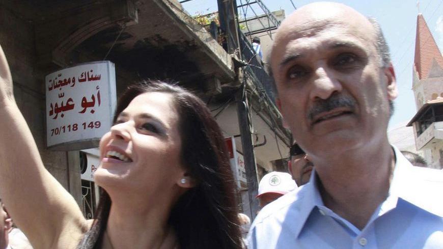 Samir Geagea, leader of the Christian Lebanese Forces, and his wife Strida greet their supporters on their way to cast their vote at a polling station in Bcharreh, northern Lebanon June 7, 2009. Lebanese Christian politician Samir Geagea said his anti-Syrian coalition would secure a slim victory in Sunday's parliamentary election, defeating a rival alliance that included the Syria- and Iran-backed Hezbollah.  REUTERS/Chamoun Daher (LEBANON POLITICS ELECTIONS IMAGES OF THE DAY)