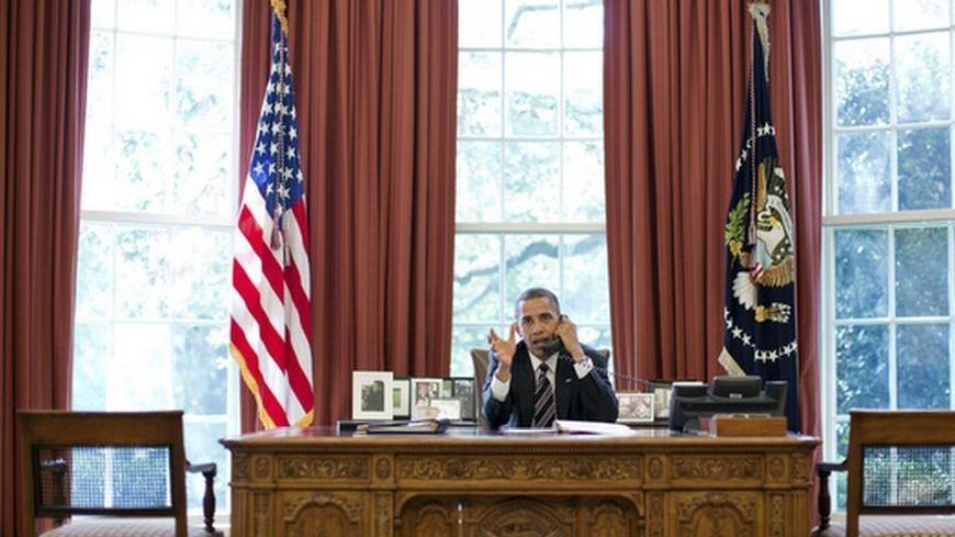 U.S. President Barack Obama speaks on the phone with Israel's Prime Minister Benjamin Netanyahu, in the Oval Office in this September 28, 2012 White House handout photograph. Obama and Netanyahu expressed solidarity on the goal of preventing Iran from acquiring a nuclear weapon, the White House said on Friday, amid signs of easing tensions over their differences on how to confront Tehran. REUTERS/Pete Souza/The White House/Handout  (UNITED STATES - Tags: POLITICS TPX IMAGES OF THE DAY) FOR EDITORIAL USE ONL