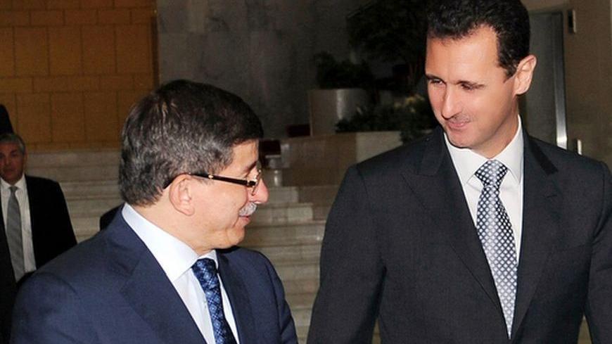 Syria's President Bashar al-Assad (C) walks with Lebanese Prime Minister Saad al-Hariri (R) and Turkish Foreign Minister Ahmet Davutoglu after a meeting in Damascus July 19, 2010. REUTERS/Sana (SYRIA - Tags: POLITICS)