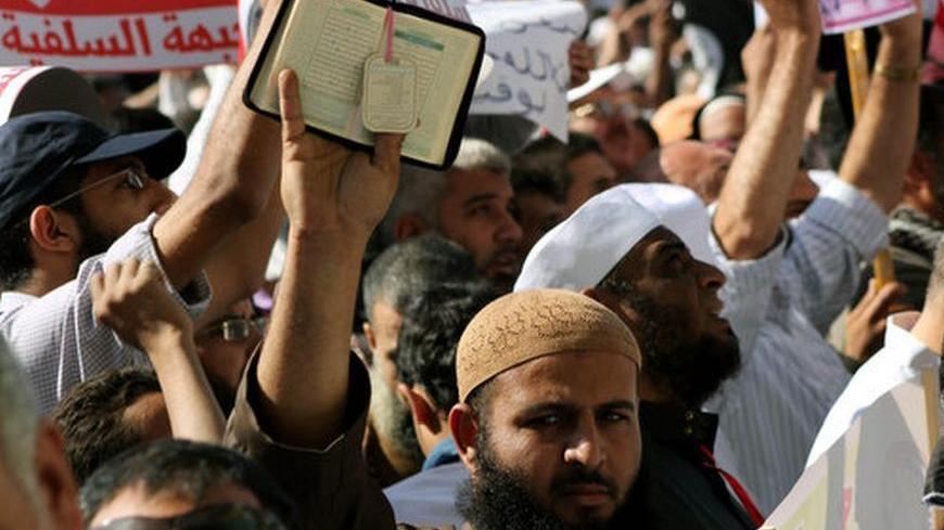 An Islamist protester holds the Quran during demonstrations demanding an Islamist constitution for Egypt on Friday, November 9.