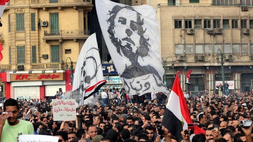 Thousands of protesters carried banners emblazoned with photos of the January 2011 uprising victims and protested President Mohamed Morsi's constitutional declaration granting him sweeping powers. Friday Nov. 23.