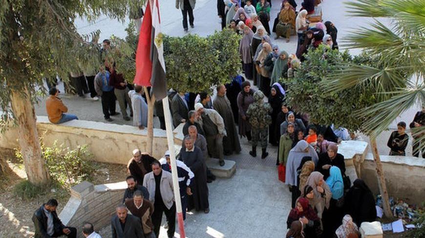 Lines of male and female voters wait at the yard of Al-Qadima Elemenrary School in Egypt's Monofeya to cast their ballots in the second phase of the constitutional referendum held on Saturday Dec. 22, 2012.
