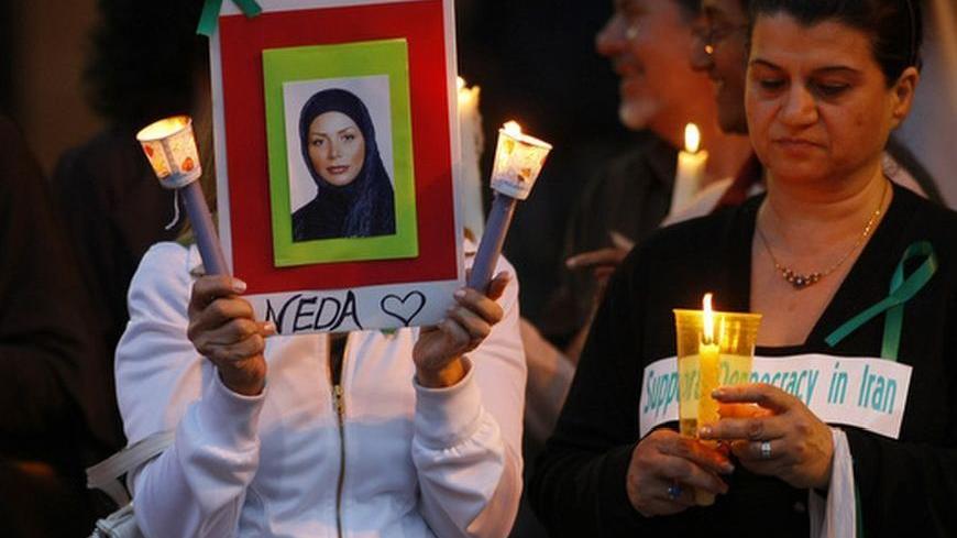 Supporters of Iranian protesters hold a candlelight vigil in memory of the recent victims from the unrest as they gather at the Federal Building in San Diego June 24, 2009. The image of Neda Agha Soltan, a young woman killed in the protest, has become an icon for the demonstrators. REUTERS/Mike Blake   (UNITED STATES CONFLICT POLITICS)