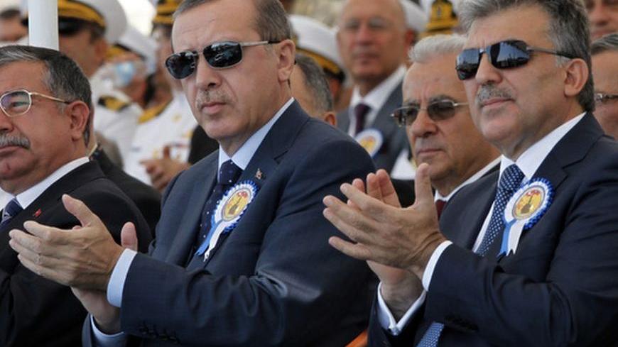 Turkey's President Abdullah Gul (R) and Turkey's Prime Minister Recep Tayyip Erdogan attend a delivery ceremony for the first nationally designed combat ship TCG Heybeliada at the Tuzla Naval shipyard in Istanbul September 27, 2011.  REUTERS/Osman Orsal (TURKEY - Tags: POLITICS MILITARY)