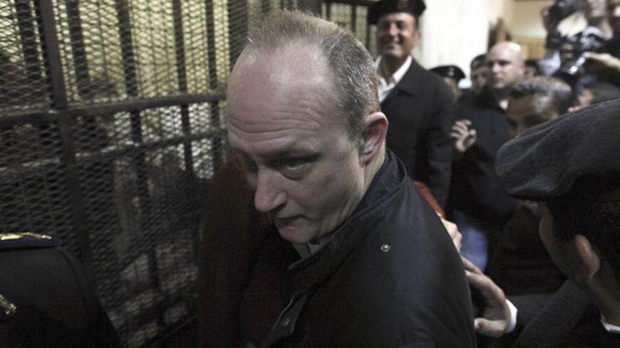 American Robert Becker of the National Democratic Institute (NDI) leaves the defendants' cage during the opening of their trial, in Cairo March 8, 2012. An Egyptian judge said on Thursday he was delaying until April 10 the trial of civil society activists including 16 Americans accused of receiving illegal foreign funds and pursuing their pro-democracy activities without a licence.  REUTERS/Mohamed Abd El Ghany  (EGYPT - Tags: CIVIL UNREST POLITICS CRIME LAW)