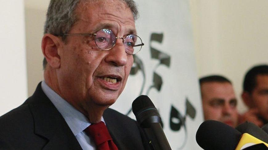Egyptian presidential candidate Amr Moussa speaks during a news conference in his campaign headquarters in Cairo, May 28, 2012. Former Arab League chief Moussa said he was open to consultation with other parties to ensure that Egypt remains a civilian democracy, and that the revolution gains are not undermined. REUTERS/Asmaa Waguih (EGYPT - Tags: POLITICS ELECTIONS)