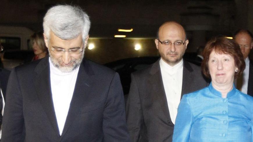 EU foreign policy chief Catherine Ashton (R) and Iran's chief negotiator Saeed Jalili (L) walk before their meeting in the garden of the Iranian Consulate in Istanbul September 18, 2012. REUTERS/Osman Orsal (TURKEY - Tags: POLITICS ENERGY)