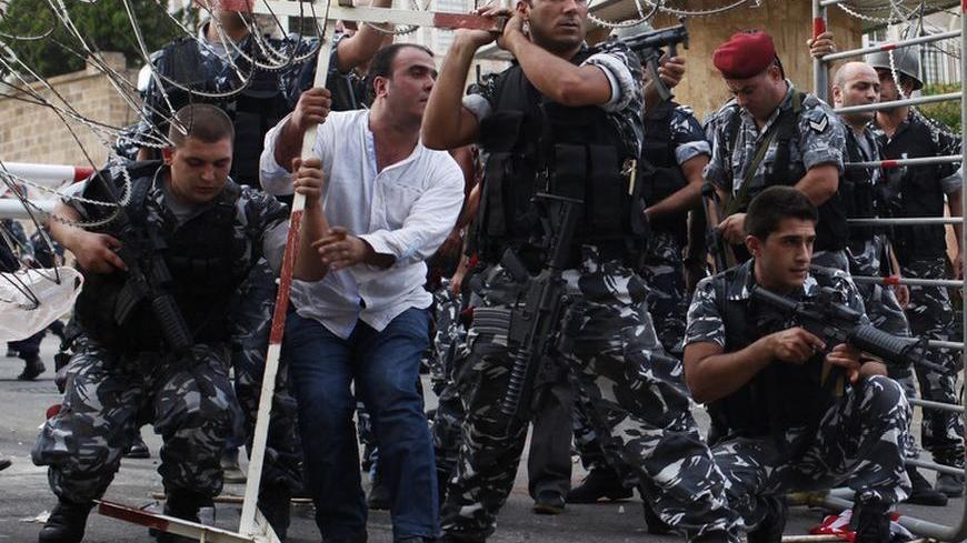 Lebanese security forces reinforce the barriers during clashes with protesters who were trying to storm the Lebanese government in Beirut October 21, 2012. Angry mourners marched on Lebanese Prime Minister Najib Mikati's offices in central Beirut on Sunday, breaking through an outer security barrier and scuffling with police who fired tear gas in response. "Mikati leave, get out," chanted hundreds of protesters following the funeral of a slain intelligence chief. REUTERS/Ahmed Jadallah (LEBANON- Tags: POLIT