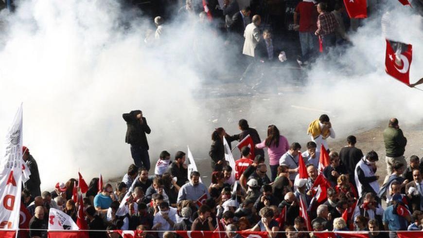 Demonstrators run as police use tear gas to disperse them in central Ankara October 29, 2012. Thousands of people gathered in the Turkish capital of Ankara on Monday to mark Republic Day and to march to the mausoleum of Mustafa Kemal Ataturk, the founder of modern Turkey. Officials had banned a rally organised by the Youth Union of Turkey (TGB) and various civil society groups and clashes broke out when police blocked the road. The crowd attempted to pass the security barrier as some demonstrators hurled pl