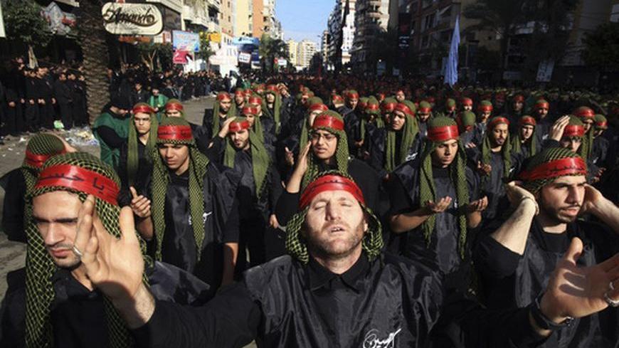 Lebanon's Hezbollah supporters gesture as they pray during a ceremony to mark Ashura in Beirut's suburbs, November 25, 2012. Hezbollah leader Sayyed Hassan Nasrallah warned Israel on Sunday that thousands of rockets would rain down on Tel Aviv and other Israeli cities if Israel attacked Lebanon. In a speech marking the Shi'ite Muslim festival of Ashura, Nasrallah said Hezbollah's response to any attack would dwarf the attacks from Gaza during the eight-day conflict between Israel and the Islamist Hamas rule