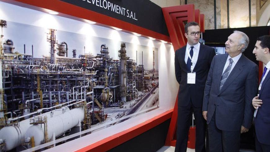 Lebanese Finance Minister Mohammed Safadi (C) tours the stands displayed at an exhibition at the Lebanon International Oil and Gas Summit in Beirut December 3, 2012.    REUTERS/Mohamed Azakir (LEBANON - Tags: ENERGY BUSINESS POLITICS)