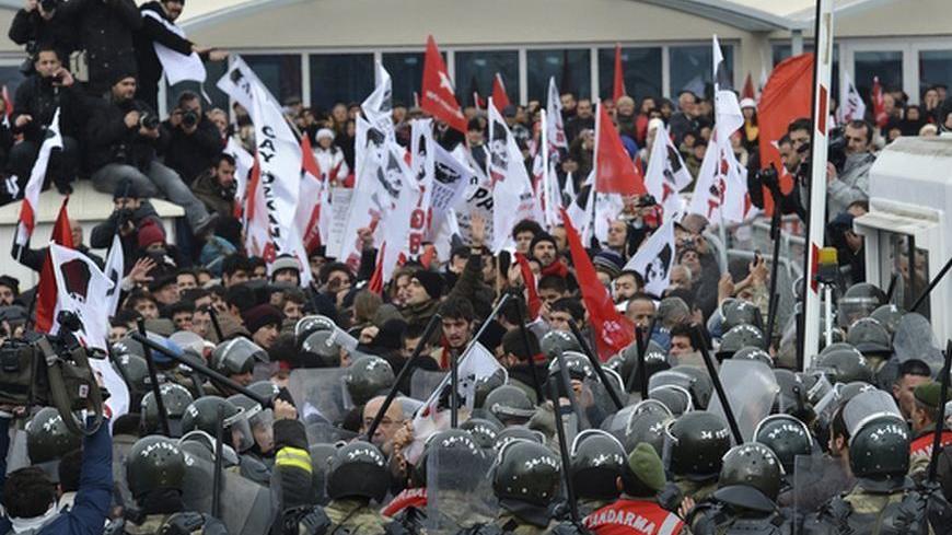 Protesters are blocked by Turkish soldiers as they try to march to a court house near Istanbul December 13, 2012. Thousands of Turkish secularists protested outside a court near Istanbul on Thursday against the trial of nearly 300 people charged with attempting to overthrow Prime Minister Tayyip Erdogan's Islamist-rooted government. Security forces wielded batons and fired pepper spray to keep crowds behind barricades in front of the courthouse at the sprawling Silivri prison complex, where dozens of the de