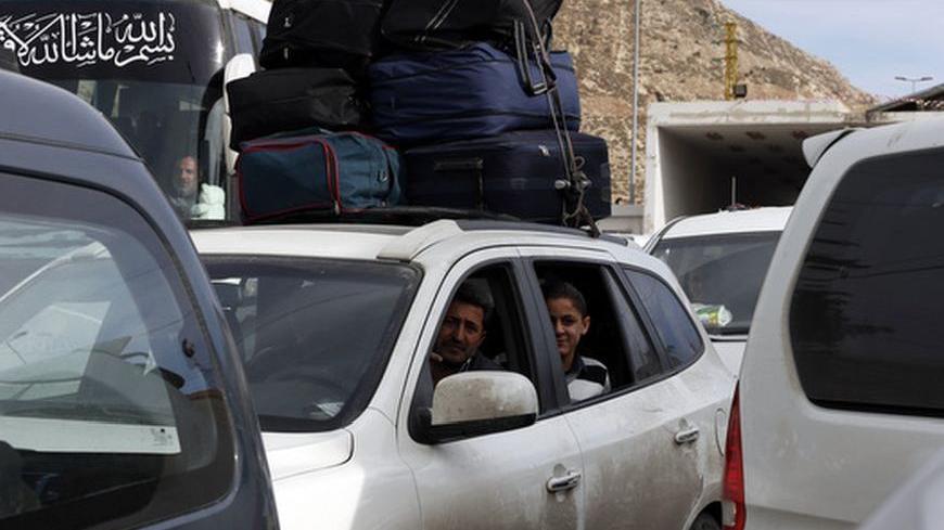A Syrian family fleeing the violence in their country, sit inside their car as they queue at the Lebanese-Syrian border, in al-Masnaa December 18, 2012. More than 1,000 Palestinian refugees living in Syria have crossed into Lebanon in the past 24 hours, a source at the Lebanese border said on Tuesday, after Syrian rebels took control of a Palestinian refugee camp in Damascus. REUTERS/Jamal Saidi  (LEBANON - Tags: POLITICS CIVIL UNREST SOCIETY IMMIGRATION)