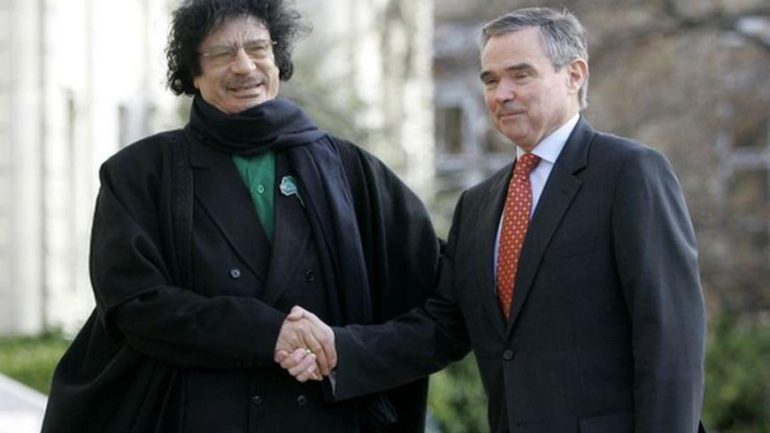 Libyan leader Moammar Gadhafi (L) is welcomed by National Assembly president Bernard Accoyer before meeting with lawmakers from France's lower house of Parliament in Paris December 11, 2007. Gaddafi is visiting France for the first time in 34 years, seeking to bolster his international standing after decades as an outcast of the West.        REUTERS/Christophe Ena/Pool    (FRANCE)