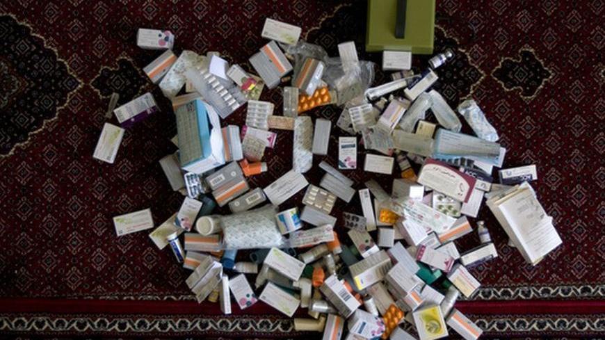 Medicine for Fayegh Fallahi, who was injured in an Iraqi chemical attack during the 1980-1988 Iran-Iraq war, is seen on the floor at his home in Nowdesheh in Kermanshah province 680 km (425 miles) southwest of Tehran July 5, 2008. High in remote Kurdish mountains, Iranian villagers still nurse ravaged eyes and lungs, 20 years after Iraqi poison gas attacks that went mostly ignored by world powers then siding with Saddam Hussein against Iran. That perceived hypocrisy continues to rankle in the Islamic Republ