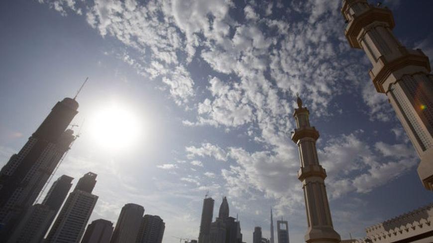The twin minaretes of a mosque are seen with office towers along Sheikh Zayed Road in Dubai, November 29, 2009. Abu Dhabi, wealthy capital of the United Arab Emirates, will "pick and choose" how to assist debt-laden neighbour Dubai, a senior official said on Saturday, after fears of a Dubai default sent global markets reeling. Dubai said earlier this week that two companies plan to delay repayment on billions of dollars of debt as a first step toward restructuring Dubai World, the conglomerate that spearhea