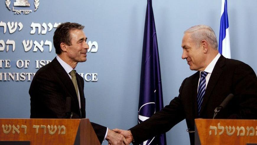 Israel's Prime Minister Benjamin Netanyahu (R) shakes hands with NATO Secretary-General Anders Fogh Rasmussen during joint statements in Jerusalem February 09, 2011. REUTERS/Uriel Sinai/Pool (JERUSALEM - Tags: POLITICS)