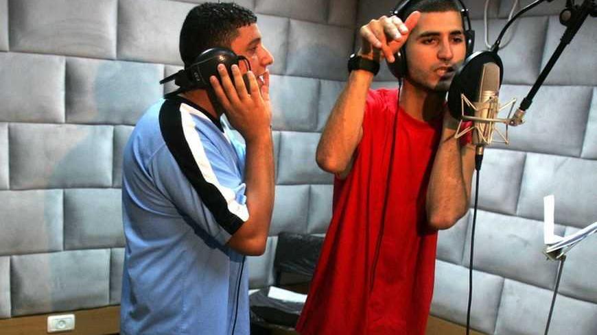 Mohammad Al-Fara (R) and Ayman Maghames practise one of their Arabic rap songs in Gaza September 20, 2006. The Palestinian youth rappers in Gaza use western music in their songs in which they said they spoke about national and social causes of the Palestinian people. REUTERS/Suhaib Salem (GAZA)