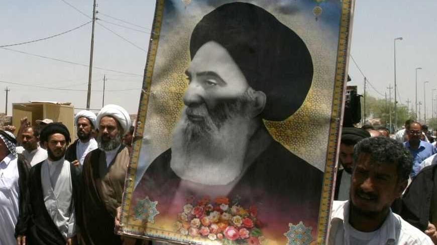 Iraqis carry a poster of top Shi'ite cleric Grand Ayatollah Ali al-Sistani during a demonstration in Najaf, 160 km (100 miles) south of Baghdad June 13, 2007. Dozens of residents took to the streets in Najaf protesting the latest bomb attack in Samarra's Golden Mosque Shi'ite shrine.     REUTERS/Ali Abu Shish    (IRAQ)