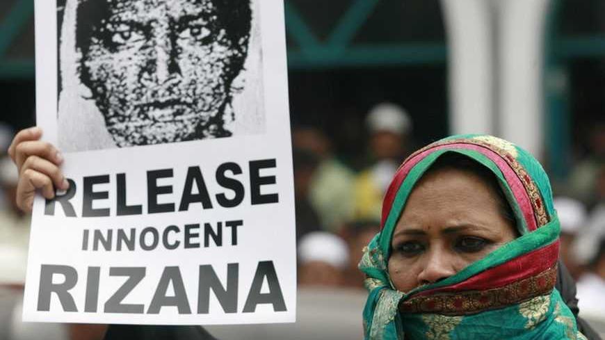 A demonstrator holds an image of Rizana Nafeek, jailed in Saudi Arabia on charges of murdering a four-month-old baby who was in her care, during a protest demanding her release in front of the Saudi Arabian embassy in Colombo July 8, 2011. Nafeek, arrested in May 2005, is currently facing execution by beheading for the crime; a charge which she has denied. REUTERS/Dinuka Liyanawatte (SRI LANKA - Tags: CRIME LAW POLITICS)
