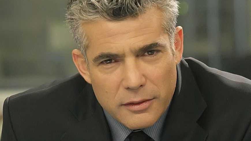Israeli anchor Yair Lapid poses for a portrait in this undated handout photo released to Reuters by Israel's Channel Two News on January 8, 2012. Lapid, a popular Israeli television news anchor, announced on Sunday he was quitting his job to run for parliament, a move seen as posing challenges for Prime Minister Benjamin Netanyahu and for his main centrist and left-of centre rivals. REUTERS/Channel 2 News/Handout (ISRAEL - Tags: POLITICS MEDIA) FOR EDITORIAL USE ONLY. NOT FOR SALE FOR MARKETING OR ADVERTISI