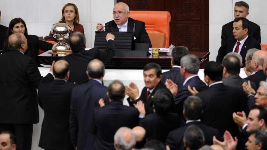Turkey's main opposition Republican People's Party (CHP) lawmakers and Parliament Chairman Cemil Cicek (rear C) argue during a debate at the parliament in Ankara February 8, 2012. REUTERS/Stringer (TURKEY - Tags: POLITICS)