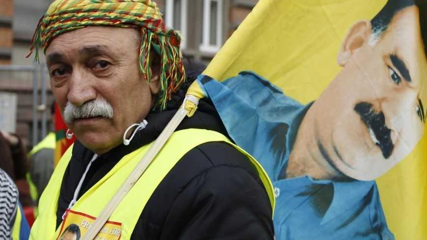 A demonstrator holds a flag with a portrait of jailed Kurdistan Workers Party (PKK) leader Abdullah Ocalan during a protest in Strasbourg February 18, 2012. Thousands of demonstrators protested in support of Ocalan, who was captured on February 15, 1999, and is currently serving a life sentence in Turkey. REUTERS/Vincent Kessler (FRANCE  - Tags: POLITICS CIVIL UNREST)