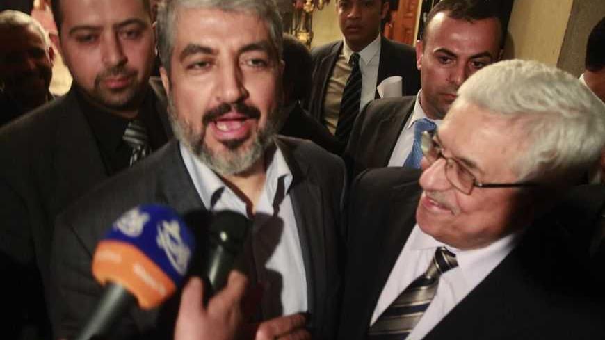 Hamas leader Khaled Meshaal (L) and Palestinian President Mahmoud Abbas (R) speak to the media after their meeting in Cairo, February 22, 2012. REUTER/Asmaa Waguih  (EGYPT - Tags: POLITICS)