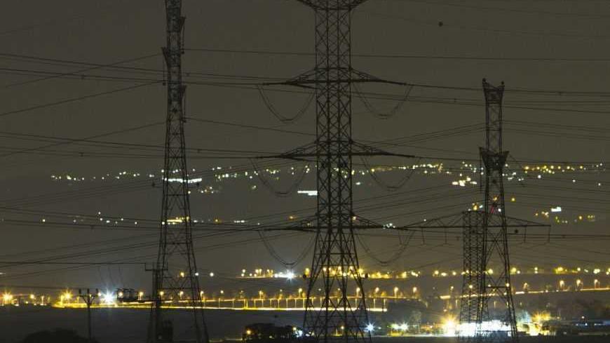Electricity pylons and power transmission lines are seen at night near Kibbutz Negba in southern Israel May 17, 2012. Israel Electric Corp (IEC), which is responsible for nearly every aspect of electricity from running power plants to connecting households, simply cannot keep up with growing demand.The state-owned utility just lost natural gas supplies from neighbouring Egypt and fuel costs are soaring. Reserves are low and capacity insufficient and the government, under pressure from massive cost-of-living