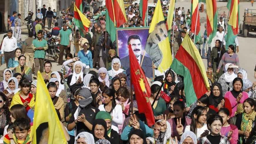 Syrian Kurds demonstrators hold flags and portraits of jailed Kurdistan Workers Party (PKK) leader Abdullah Ocalan during a protest in Derik, Hasakah November 1, 2012. Around 1,000 Syrian Kurds protested in the north-eastern Syrian town of Derik on Thursday, demanding the re-opening of Kurdish-language schools they said were closed by President's Bashar al-Assad's regime.  REUTERS/Thaier al-Sudani (SYRIA - Tags: POLITICS CIVIL UNREST CONFLICT EDUCATION)