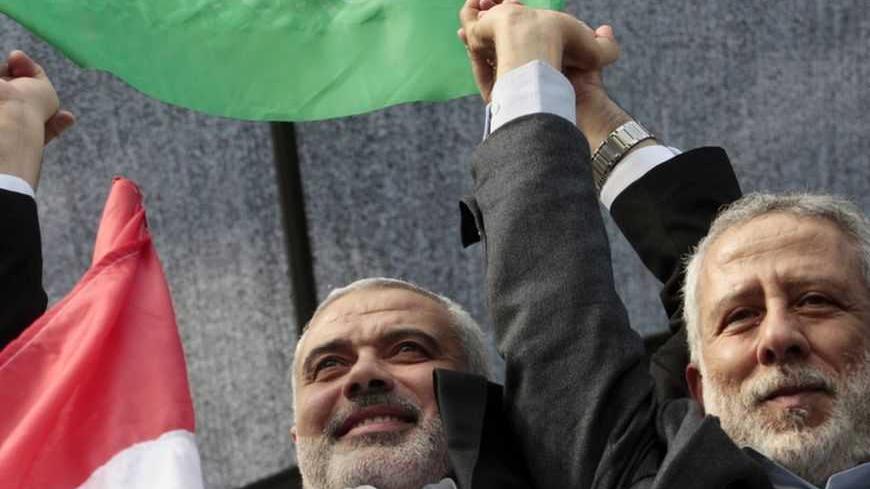 Senior Hamas leader Ismail Haniyeh (L) and Islamic Jihad leader Mohammed Al-Hindi celebrate what Palestinians say is a victory over Israel after an eight-day conflict, during a rally in Gaza City November 22, 2012. A ceasefire between Israel and Gaza's Hamas rulers took hold on Thursday after eight days of conflict, although deep mistrust on both sides cast doubt on how long the Egyptian-sponsored deal can last. REUTERS/Ahmed Zakot (GAZA - Tags: MILITARY CONFLICT POLITICS)