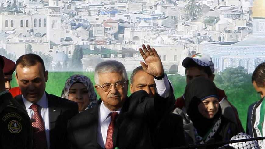 Palestinian President Mahmoud Abbas (front row 2nd L) waves during a rally marking the U.N. General Assembly's upgrading of the Palestinians' status from "observer entity" to "non-member state", in the West Bank city of Ramallah December 2, 2012. Israel said on Sunday it was withholding this month's transfer of tax revenues to the Palestinian Authority, after the United Nations' de facto recognition of a Palestinian state.  REUTERS/Ammar Awad (WEST BANK - Tags: POLITICS CIVIL UNREST)