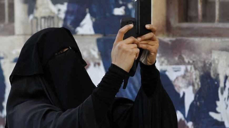 A protester uses a mobile device to take a video of an anti-government protest in the capital Manama December 17, 2012. Protesters, shouting anti-government slogans, attempted to regroup from various points to march against a ban on demonstrations. Riot police dispersed them and arrested at least three protesters. REUTERS/Hamad I Mohammed (BAHRAIN - Tags: POLITICS CIVIL UNREST)