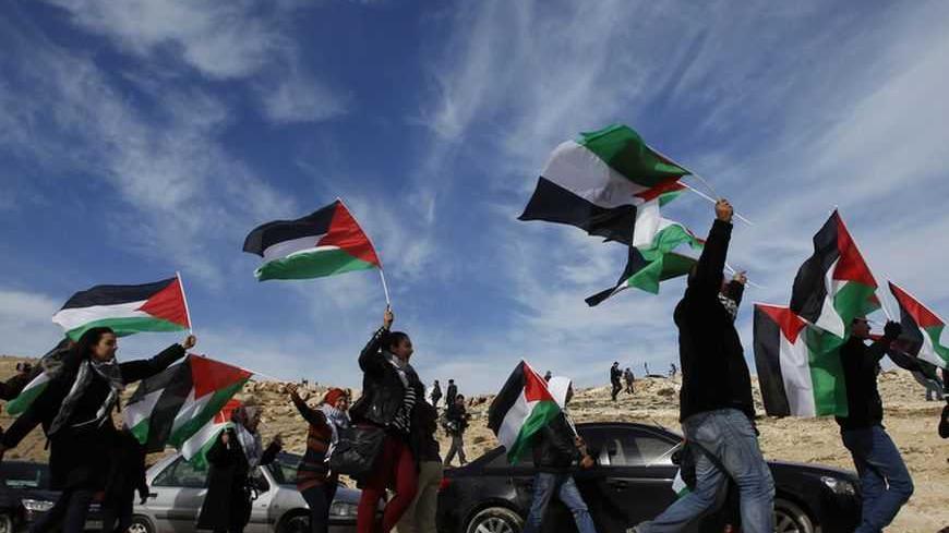 Palestinians, together with Israeli and foreign activists, demonstrate as they walk around newly-erected tents in an area known as E1, near Jerusalem  January 12, 2013. Palestinians from villages in the occupied West Bank near Jerusalem pitched tents on Friday on the land Israel has earmarked for a new urban settlement, looking to preserve the area for an independent Palestinian state.  REUTER/ Baz Ratner (WEST BANK - Tags: POLITICS CIVIL UNREST BUSINESS CONSTRUCTION TPX IMAGES OF THE DAY)