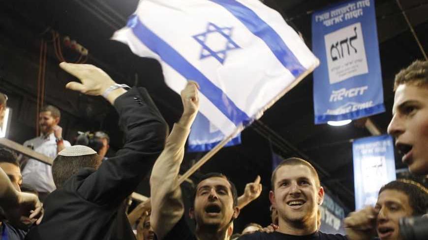 Supporters of Prime Minister Benjamin Netanyahu's Likud party celebrate after the exit polls were announced at the party's headquarters in Tel Aviv January 22, 2013. Hawkish Prime Minister Benjamin Netanyahu emerged the bruised winner of Israel's election on Tuesday, claiming victory despite unexpected losses to resurgent centre-left challengers. REUTERS/Nir Elias (ISRAEL - Tags: POLITICS ELECTIONS)