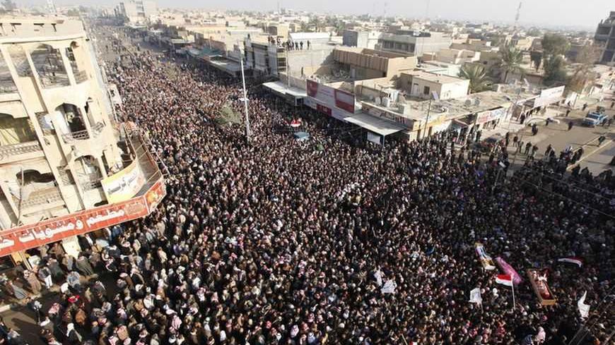 Residents carry coffins during the funeral of victims killed in clashes with security forces in Falluja, 50 km (30 miles) west of Baghdad, January 26, 2013. Thousands of mourners attended on Saturday a funeral procession for protesters killed on the day before in Falluja during clashes with Iraqi soldiers in the wake of protest against government of Shi'ite Prime Minister Nuri al-Maliki. At least three people were killed on Friday when Iraqi troops opened fire during clashes with Sunni protesters in Falluja