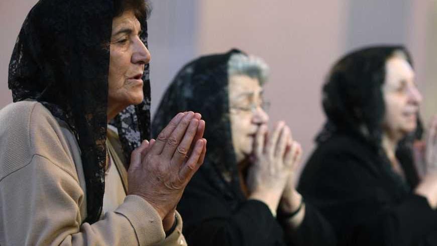 Armenian women, members of Turkey's Armenian community, pray during a Sunday mass at the Surp Asdvadzadzin Patriarchal Church in Istanbul October 11, 2009. Turkey signed accords to normalise ties with Armenia in Switzerland on Saturday in a step towards ending a century of hostility. REUTERS/Murad Sezer (TURKEY POLITICS RELIGION) - RTXPJ2K
