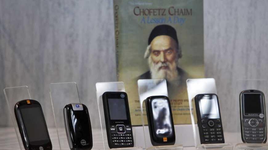 Kosher cellular phones, imported and distributed by Israeli Accel Telecom, are displayed at the company's offices in Tel Aviv May 2, 2011. Hundreds of thousands of cellphones, popularly dubbed kosher because they block access to services frowned upon by ultra-Orthodox rabbis, have been operating in the Jewish state for more than five years. Last month, Israel's second largest mobile provider, Partner introduced what it hailed as the world's first Yiddish cellphone, manufactured by Alcatel-Lucent. Picture ta