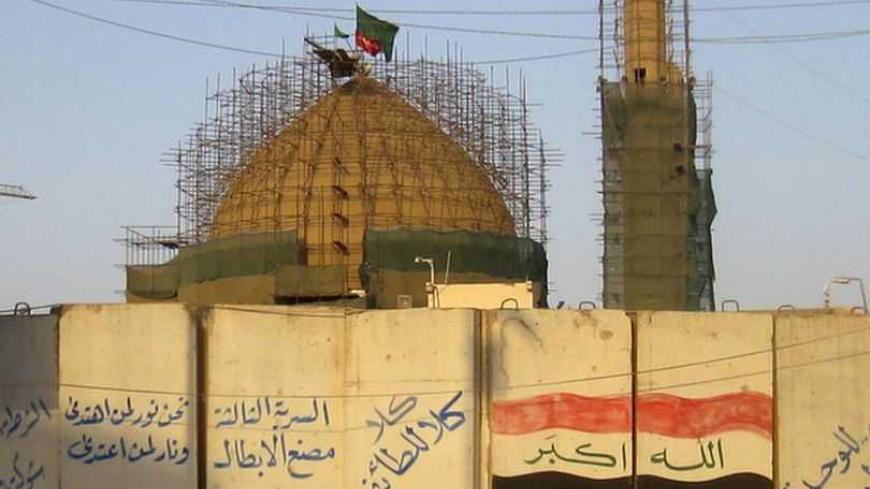 A view of blast walls in front of the Shi'ite Askari shrine in Samarra, 100 km (62 miles) north of Baghdad, August 10, 2011. Five years ago, a blast tore through Iraq's golden-domed Shi'ite Askari shrine in the mainly Sunni city of Samarra, helping ignite two years of sectarian strife that drove Iraq to the brink of civil war. Now the shrine is being rebuilt and Shi'ite authorities are buying up nearby estates from Sunni residents to expand the mosque, risking reopening old sectarian wounds just as the last
