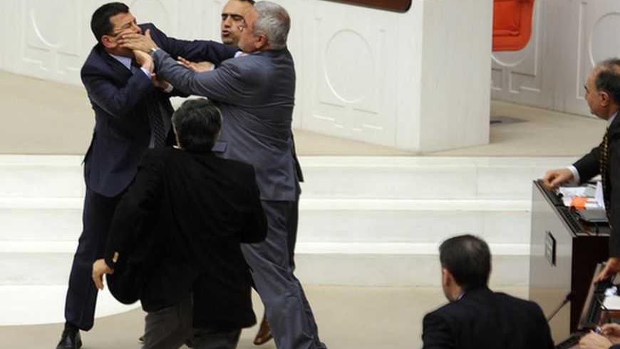 Members of parliament from the ruling AK Party (AKP) and Republican People's Party (CHP) scuffle during a debate at the parliament in Ankara early March 30, 2012. The Turkish parliament is hotly debating a bill overturning a 1997 law, imposed with the backing of the military, which extended compulsory education to eight from five years and stopped under-15s attending religious "imam hatip" schools. Parliamentarians on Thursday accepted a proposal from Prime Minister Tayyip Erdogan's AK Party to offer option