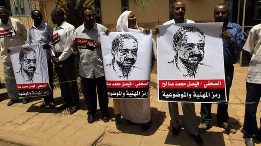 Journalists carry banners depicting journalist Faisal Mohamed Saleh during a demonstration against violations of the security services to the press and journalists outside the Council of the Press and Publication, Khartoum May 16, 2012. The banners read, "Journalist Faisal Mohamed Saleh is a symbol of professionalism and objectivity". Saleh was detained and grilled for hours about his interview after he criticised Sudan's President Omar Hassan al-Bashir on Al Jazeera television for calling the rulers of Sou
