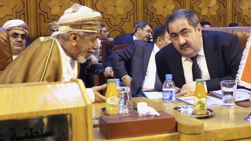 Iraq's Foreign Minister Hoshiyar Zebari (R) talks with an Omani Foreign Affairs representative as they attend the Arab League foreign ministers' meeting on Syria at the Arab League headquarters in Cairo November 12 , 2012.   REUTERS/Asmaa Waguih (EGYPT - Tags: POLITICS) - RTR3ABK8
