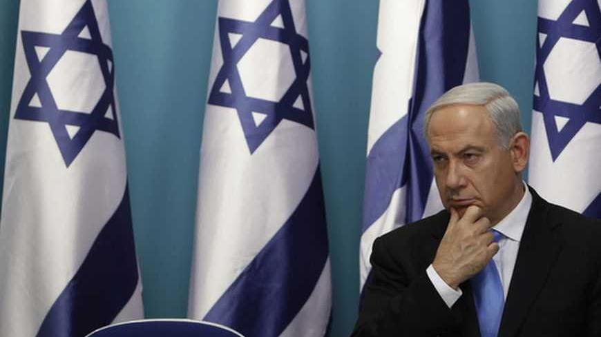 Israel's Prime Minister Benjamin Netanyahu sits after delivering a statement in Jerusalem November 21, 2012. Netanyahu hinted on Wednesday that if an Egyptian-brokered truce with Islamist militants in Gaza did not work Israel would consider "more severe military action" against the Palestinian territory. REUTERS/Baz Ratner (JERUSALEM - Tags: POLITICS CONFLICT)