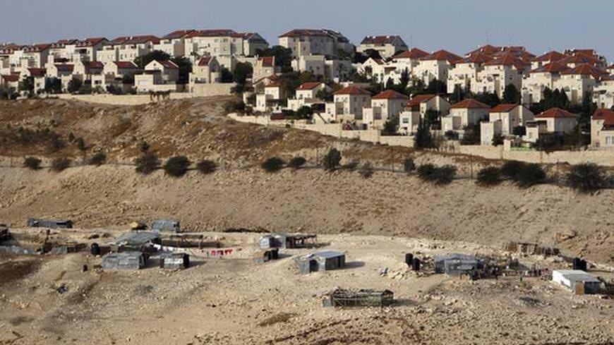 A Bedouin encampment of the Jahalin tribe is seen in front of the Jewish settlement of Maale Adumim, near Jerusalem December 3, 2012. Israel will not backtrack on a settlement expansion plan that has drawn strong international condemnation, an official in Prime Minister Benjamin Netanyahu's office said on Monday. REUTERS/Ammar Awad (WEST BANK - Tags: BUSINESS CONSTRUCTION POLITICS TPX IMAGES OF THE DAY) - RTR3B60W