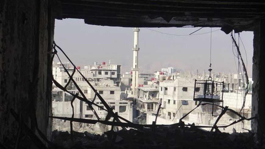 View of buildings damaged by what activists said were shelling by Syrian force loyal to President Bashar al-Assad in Erbeen, near Damascus December 31, 2012. Picture taken December 31, 2012.   REUTERS/Bassam Al-Erbeeni/Shaam News Network/Handout (SYRIA - Tags: POLITICS CIVIL UNREST) FOR EDITORIAL USE ONLY. NOT FOR SALE FOR MARKETING OR ADVERTISING CAMPAIGNS. THIS IMAGE HAS BEEN SUPPLIED BY A THIRD PARTY. IT IS DISTRIBUTED, EXACTLY AS RECEIVED BY REUTERS, AS A SERVICE TO CLIENTS