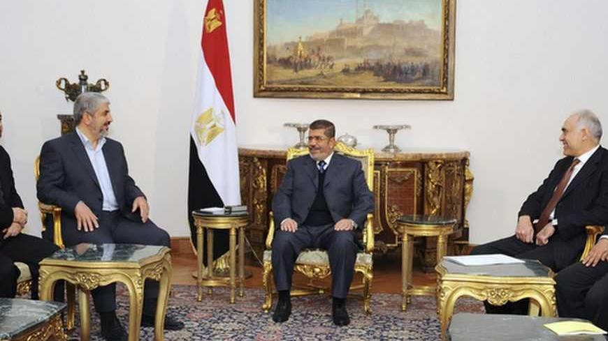 Egyptian President Mohamed Mursi (C) talks with Hamas chief Khaled Meshaal (3rd L) during their meeting in Cairo in this picture provided by the Egyptian Presidency January 9, 2013. REUTERS/Egyptian Presidency/Handout (EGYPT - Tags: POLITICS) ATTENTION EDITORS ? THIS IMAGE WAS PROVIDED BY A THIRD PARTY. FOR  EDITORIAL USE ONLY. NOT FOR SALE FOR MARKETING OR ADVERTISING CAMPAIGNS. THIS PICTURE IS DISTRIBUTED EXACTLY AS RECEIVED BY REUTERS, AS A SERVICE TO CLIENTS