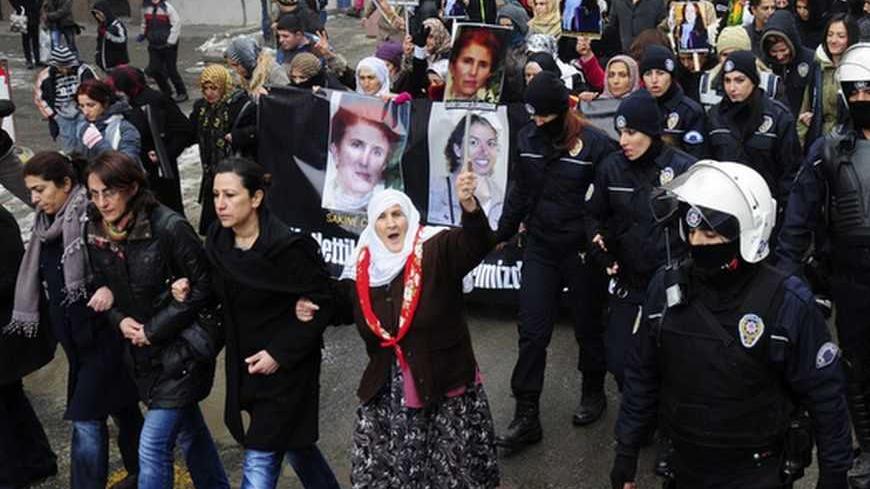 Turkish Kurdish demonstrators march with pictures of slain Kurdish activists during a protest in Diyarbakir, southeastern Turkey, January 12, 2013. Three female Kurdish activists, including a founding member of the PKK rebel group, were found shot dead in Paris on Thursday, in execution-style killings condemned by Turkish politicians trying to broker a peace deal. REUTERS/Stringer (TURKEY - Tags: POLITICS CRIME LAW CIVIL UNREST)