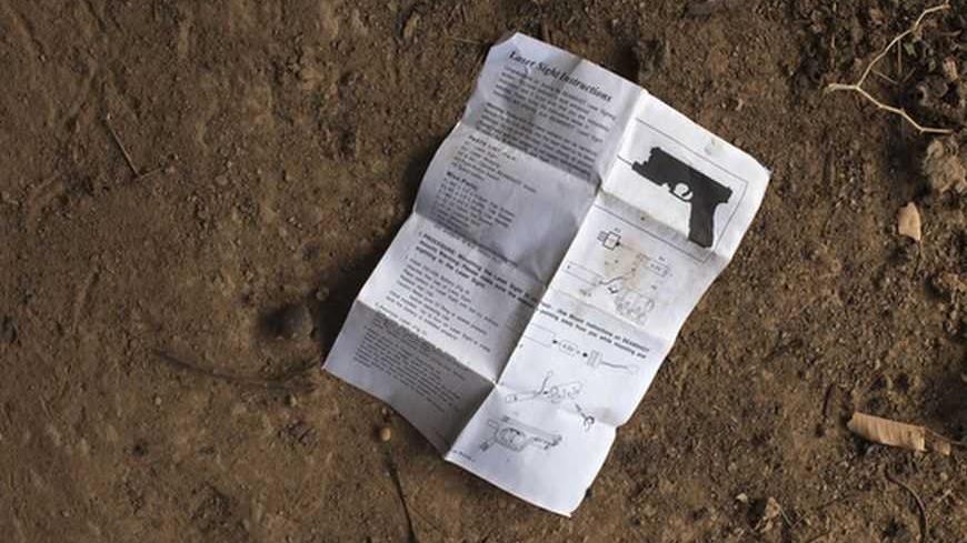 An English-language manual for installing laser sight on gun, believed to belong to Islamist rebels, lies in the courtyard of local resident Issa Dembele's house in Diabaly January 23, 2013. Dembele said the rebels took over his house when they took control of Diabaly last week to store weapons and munitions. The munitions were later abandoned during fighting between the rebels and the French and Malian militaries. REUTERS/Joe Penney (MALI - Tags: MILITARY CIVIL UNREST POLITICS CONFLICT)